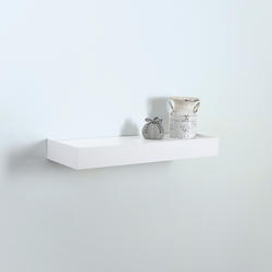 White floating shelves are mounted beside glass front cabinets positioned  over a white and gray…