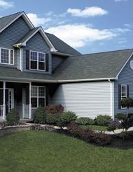 Vinyl Monogram 46 siding - Pacific Blue with a treated deck