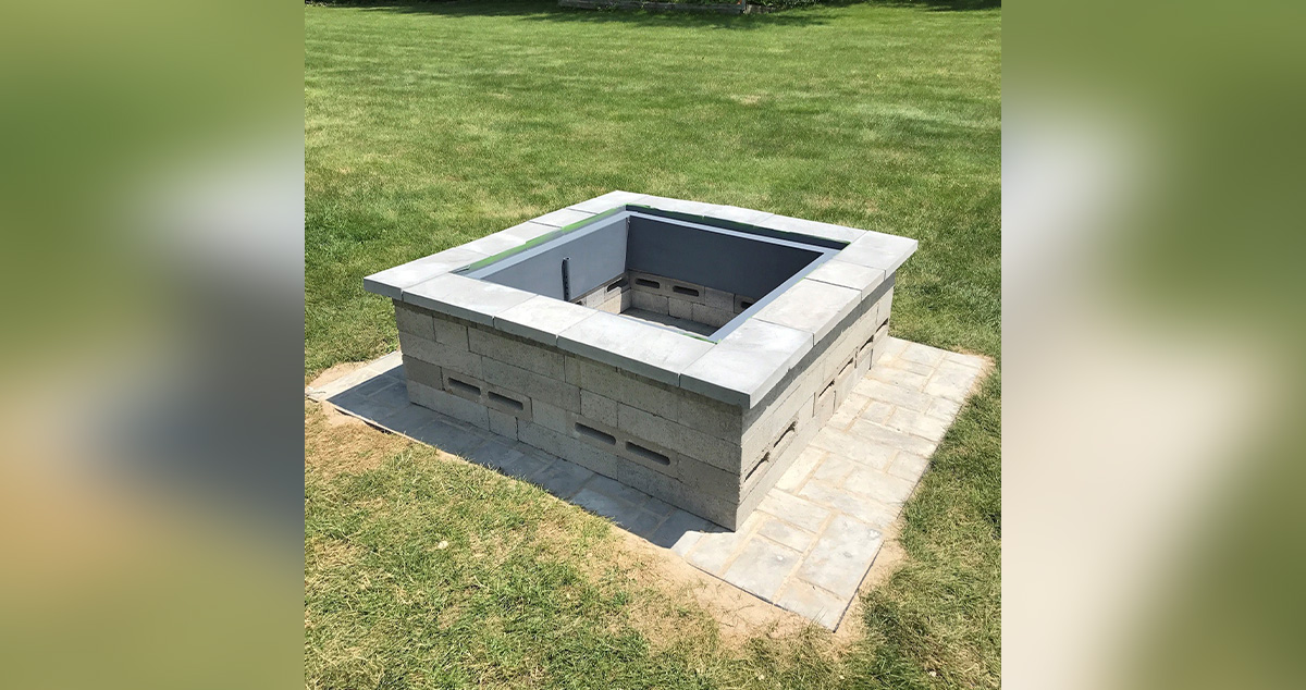 Fire pit with cinder block benches and stone surrounding.